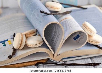 A stack of macarons and vanilla beans on a plate, a happy event