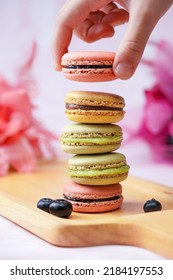 A stack of macaroons on colorful background.