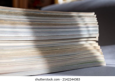 A stack of magazines against a gray background. Close-up of old print editions.