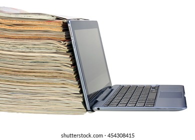Stack of magazines and laptop isolated on white background with clipping path