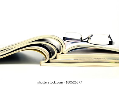 Stack of magazines with nerd glasses