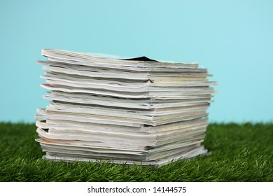 Stack Of Magazines On Green Grass Outside