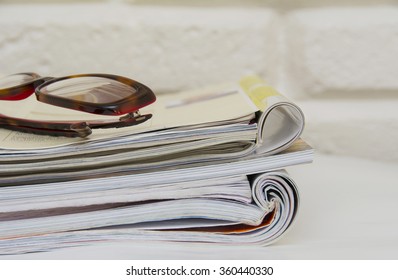 Stack of magazines on table, close up