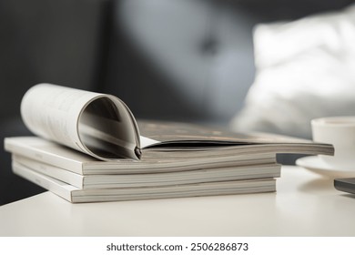 Stack of Magazines on White End Table in Living Room