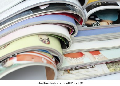 stack of magazines on whith background