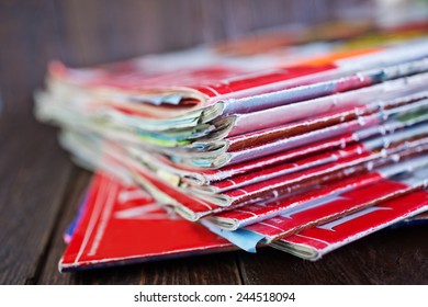 stack of magazines on the wooden table