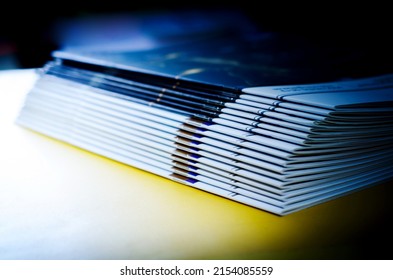 stack of magazines on yellow background, isolated