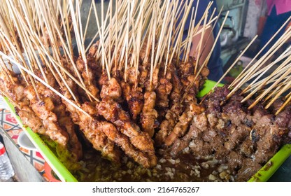 Stack of marinated chicken satay ready to be grilled