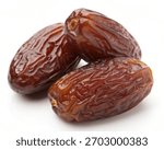 Stack of Medjool Dates behind on white background