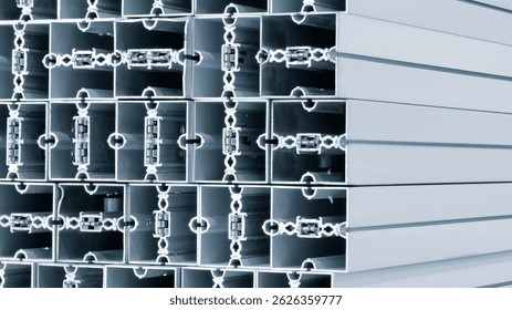 Stack of metal structural parts with square cross-section and many small holes. Industrial constructions for building background