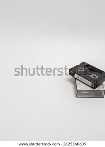 Stack of MiniDV Tapes on White Background with Copy Space