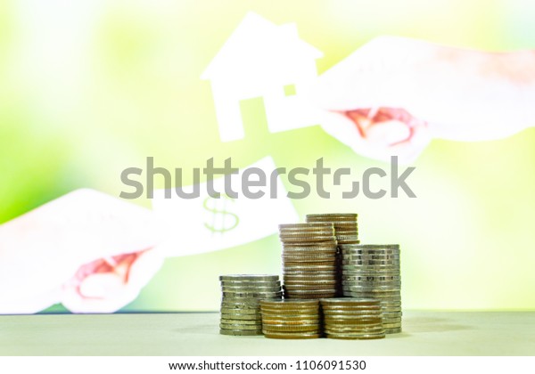 Stack of money with blured of pay housing on\
background , finance concept,saving money concept,save\
money,prepare life for the\
future
