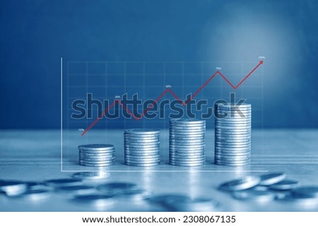 Stack of money coin with graph and chart, financial investment concept with blue filter. 