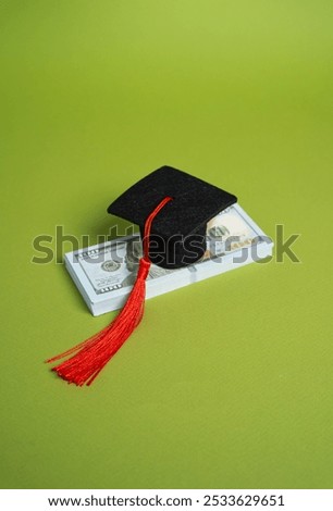 A stack of money and a graduation cap. Concept of a loan for education. Educational grants. Student loan concept. Educational grants. Unaffordable and expensive. High paying jobs.