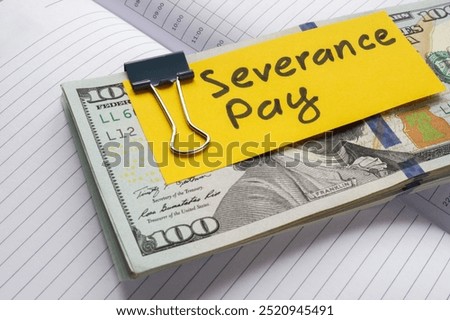 Stack of money labeled severance pay. Financial support during job transition.