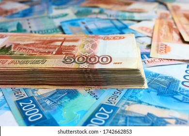 Stack of money Russian bills on a background of money. The face value of banknotes is 5000 five, 2000 two and 1000 one thousand rubles.
