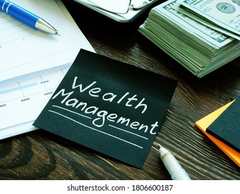 Stack of money and wealth management sign on the black sheet. - Shutterstock ID 1806600187