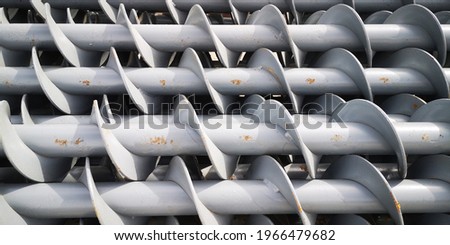stack of mounted screws painted grey