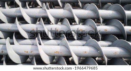 stack of mounted screws painted grey