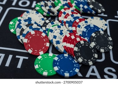 Stack of multicolored poker chips close up representing casino games, risk, gambling and betting concept