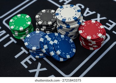 Stack of multicolored poker chips close up representing casino games, risk, gambling and betting concept