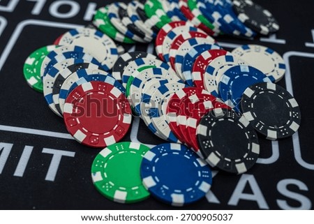 Stack of multicolored poker chips close up representing casino games, risk, gambling and betting concept