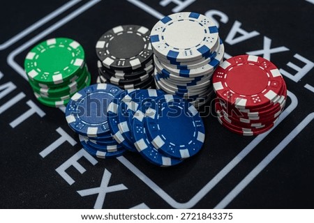 Stack of multicolored poker chips close up representing casino games, risk, gambling and betting concept