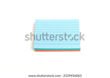 A stack of multi-colored stickers with blue in the middle. Blue is the only one that is not multicolored. Note paper isolated on white background.
