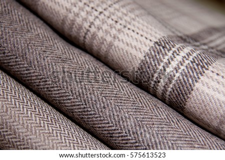 Stack of neutral colored tweed wool fabric