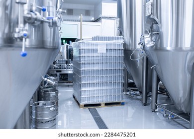 a stack of new aluminium cans on the manufacture, cold drink beverages production. Pallet of metal cans