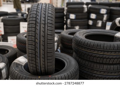 A stack of new car tires in a store. 