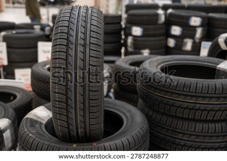 A stack of new car tires in a store. 