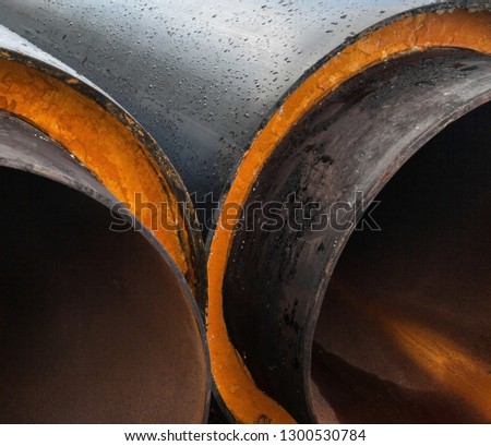 Stack of new gray metal pipes (tubes). Fluid conveyance. Pipeline construction.