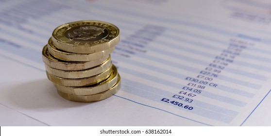 Stack Of New Pound Coins On Financial Figures Balance Sheet