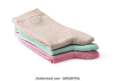 Stack of new tall colorful socks isolated on a white background. Three pairs of beige, green and pink socks folded in half. Elastic cotton hosiery. Full depth of field. Front view.
