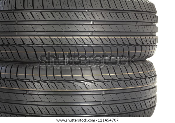 Stack of new tires. Brand new tires stacked\
up, isolated on white\
background
