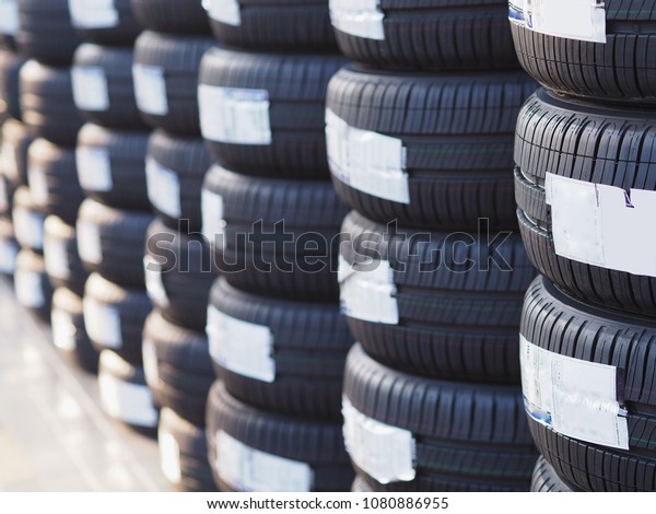 Stack of new\
tires in tire installation\
service.