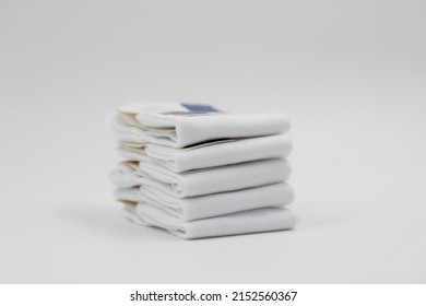 Stack Of New White Socks Isolated On Light Background, Close-up