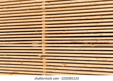 Stack of new wooden studs at the lumber yard - Shutterstock ID 2233301153
