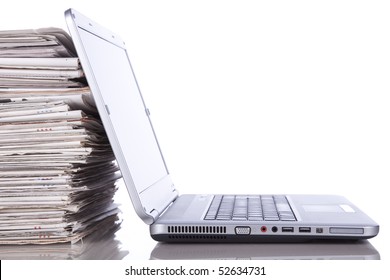 Stack Of Newspaper Next To A Laptop (isolated On White)