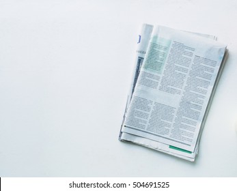 Stack Newspaper On White Desk With Copy Space