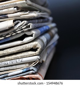 Stack of newspapers on black background