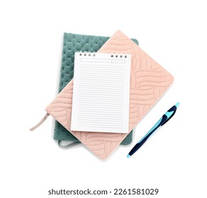 Stack of notebooks and pen on white background