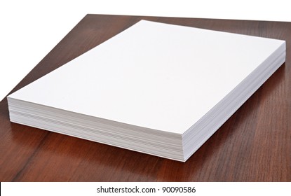 Stack Of Office Paper On Wooden Table Isolated On A White Background