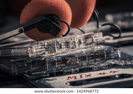 Stack of old audio cassettes and headphones