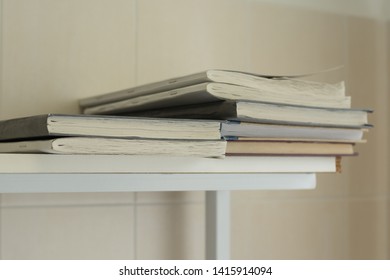 A stack of old battered work logs on a wooden shelf. vintage style