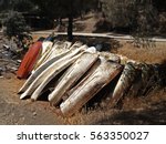 Stack of old boats in grass