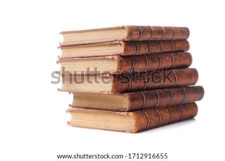 A stack of old books bound in brown leather, isolated on a white background. Space for text