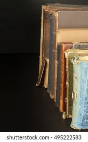 Stack of old books, copyspace for your text. Antique books on old wooden shelf. 