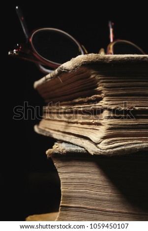 stack of old books and glasses, selective focus